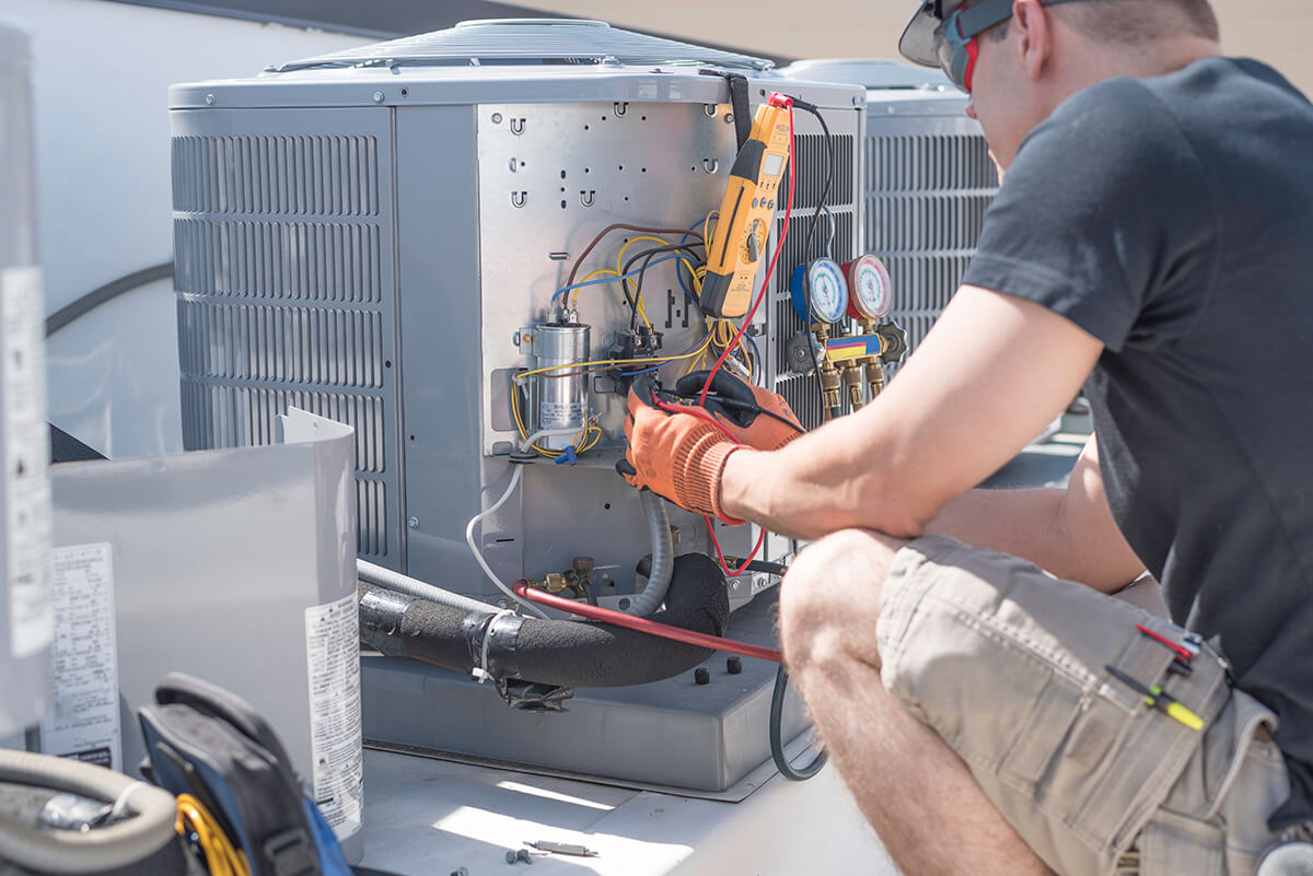 HVAC technician working on controls